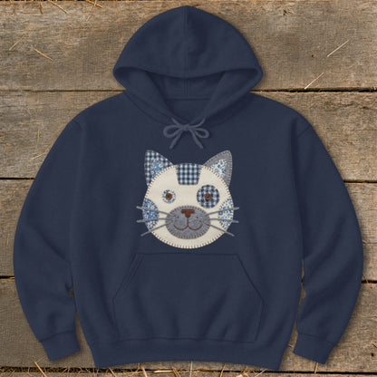 Navy hoodie with a patchwork cat face applique on the chest.