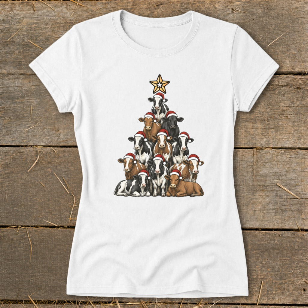 White t-shirt with cows arranged in a Christmas tree shape, wearing Santa hats, topped with a star.