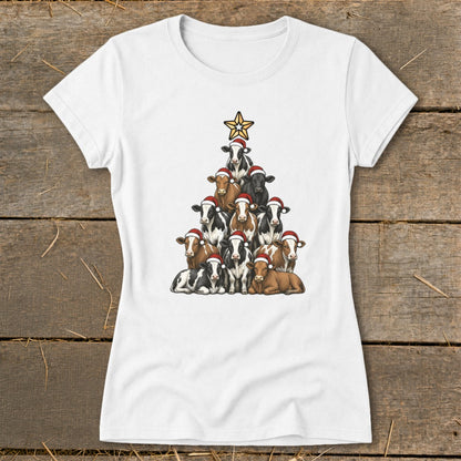 White t-shirt with cows arranged in a Christmas tree shape, wearing Santa hats, topped with a star.