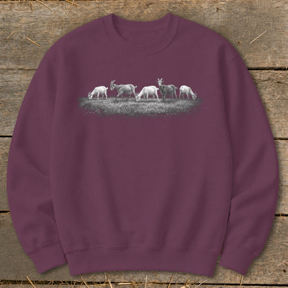 Maroon sweatshirt with a graphic of five goats grazing on grass.