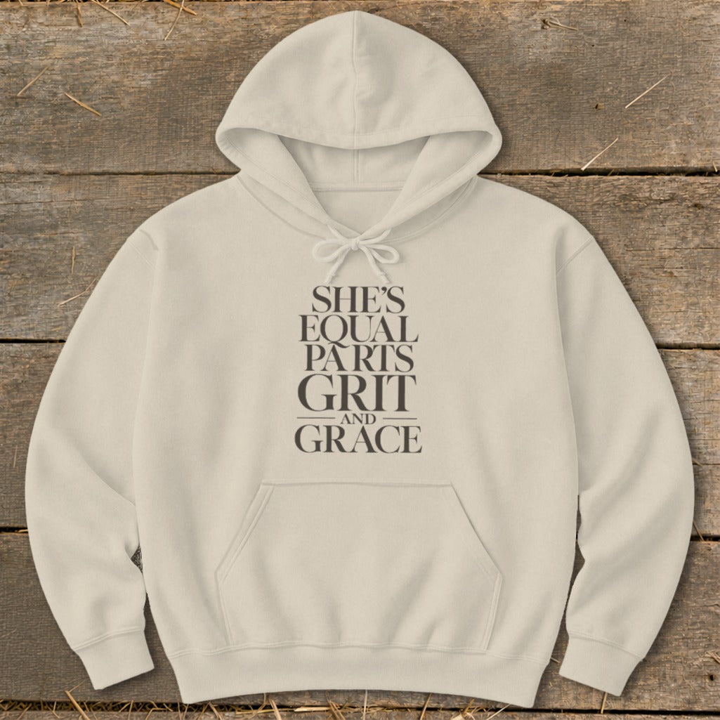 Cream hoodie with "She's Equal Parts Grit and Grace" text design.