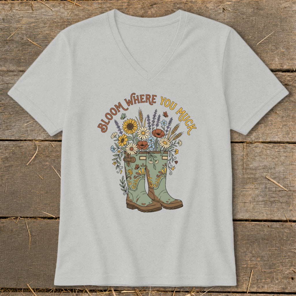 Gray v-neck t-shirt with green boots and flowers graphic with text "Bloom Where You Muck."