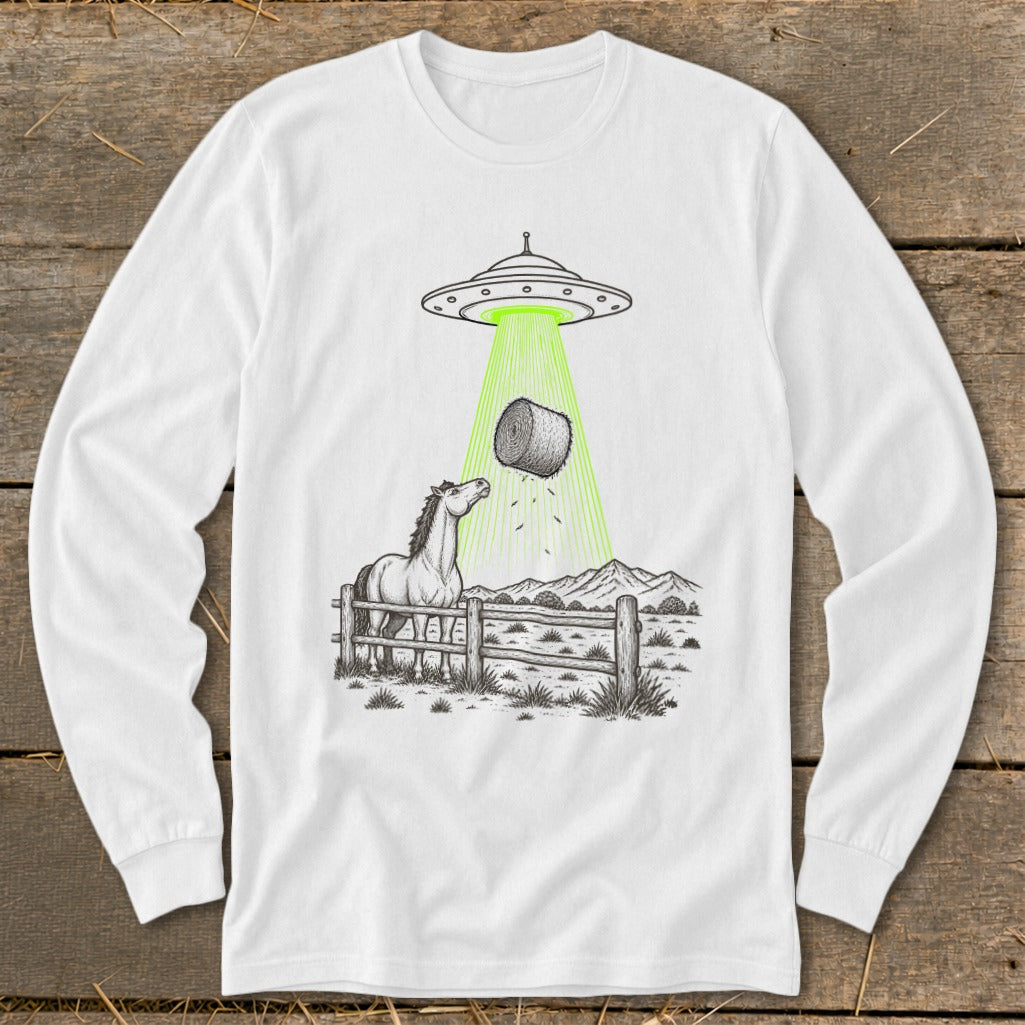 Horse in pasture looks up at UFO beam abducting a bale of hay.