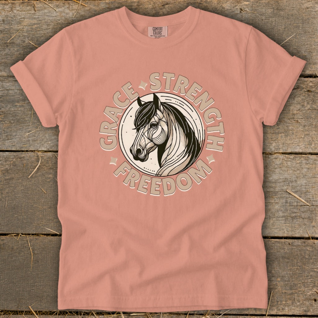 Peach t-shirt with horse graphic and text "Grace Strength Freedom"