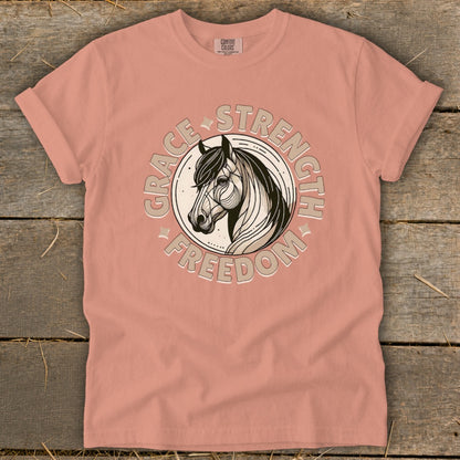 Peach t-shirt with horse graphic and text "Grace Strength Freedom"