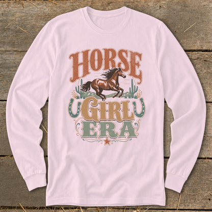 Pink long-sleeve shirt with a graphic of a horse and text "HORSE GIRLU ERA".