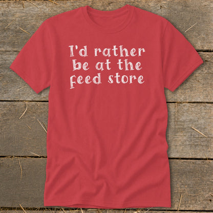 Red t-shirt with white text reading "I'd rather be at the feed store".