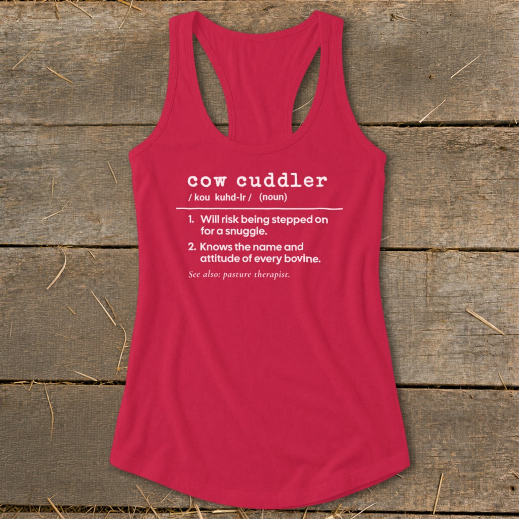 Pink tank top with white text defining "cow cuddler" and its characteristics.