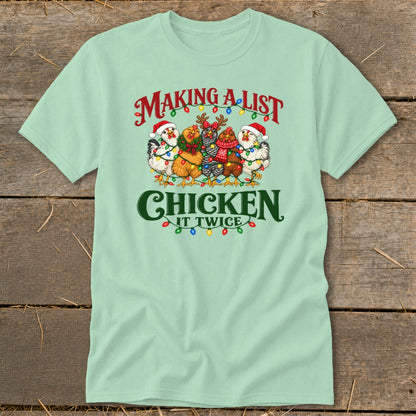 Mint green t-shirt with chickens wearing Santa hats and Christmas lights, text reads "Making a list, Chicken it twice."