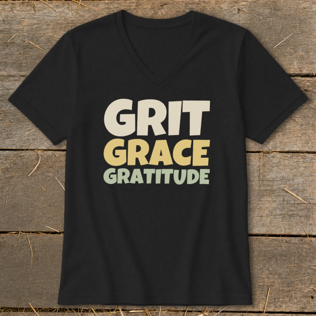 Black V-neck t-shirt with the words Grit, Grace, Gratitude printed on the chest in cream, yellow, and green.