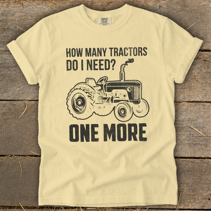 Yellow t-shirt with "How Many Tractors Do I Need? One More" and tractor graphic.