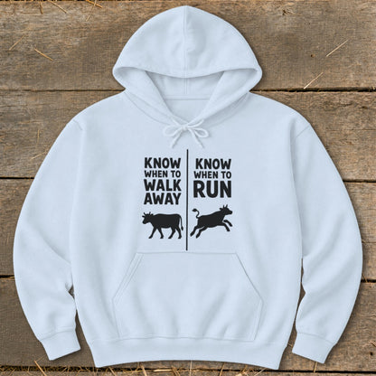 White hoodie with black text and cow graphics: "Know When to Walk Away" and "Know When to Run".