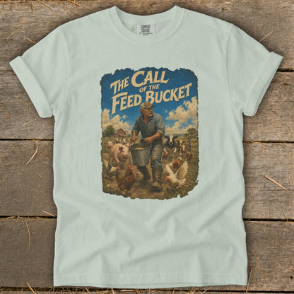 T-shirt graphic: "The Call of the Feed Bucket" with farmer feeding farm animals.