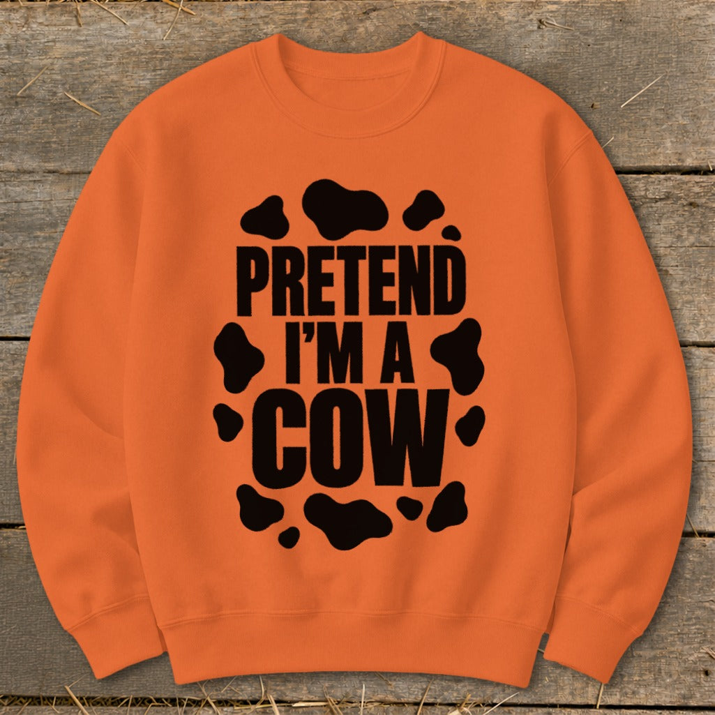 Orange sweatshirt with black text "PRETEND I'M A COW" and cow spots.