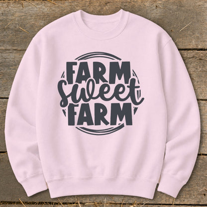 Pink sweatshirt with "Farm Sweet Farm" text design.