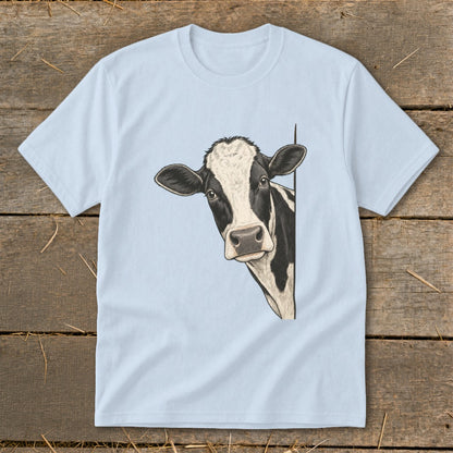 Black and white cow peeking from behind a light blue t-shirt.