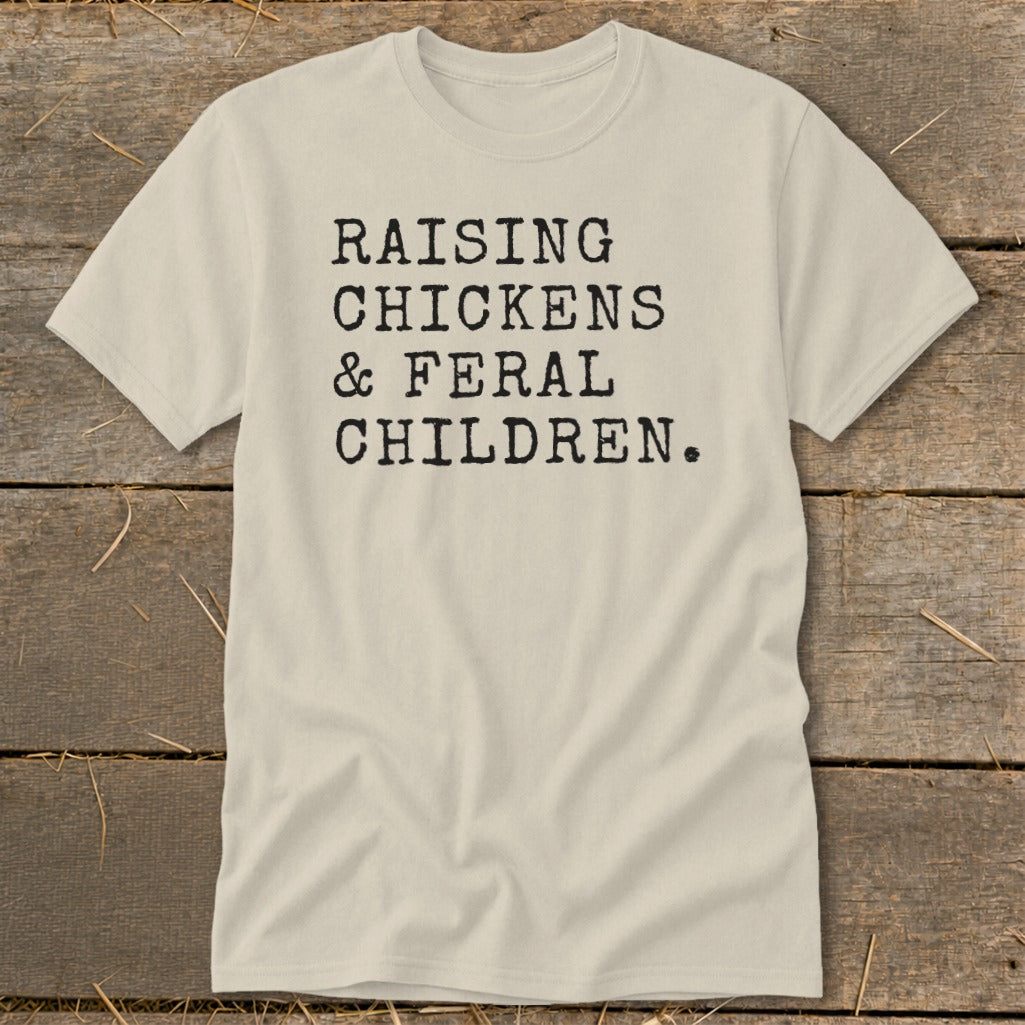 Light tan t-shirt with black text reading "RAISING CHICKENS & FERAL CHILDREN."