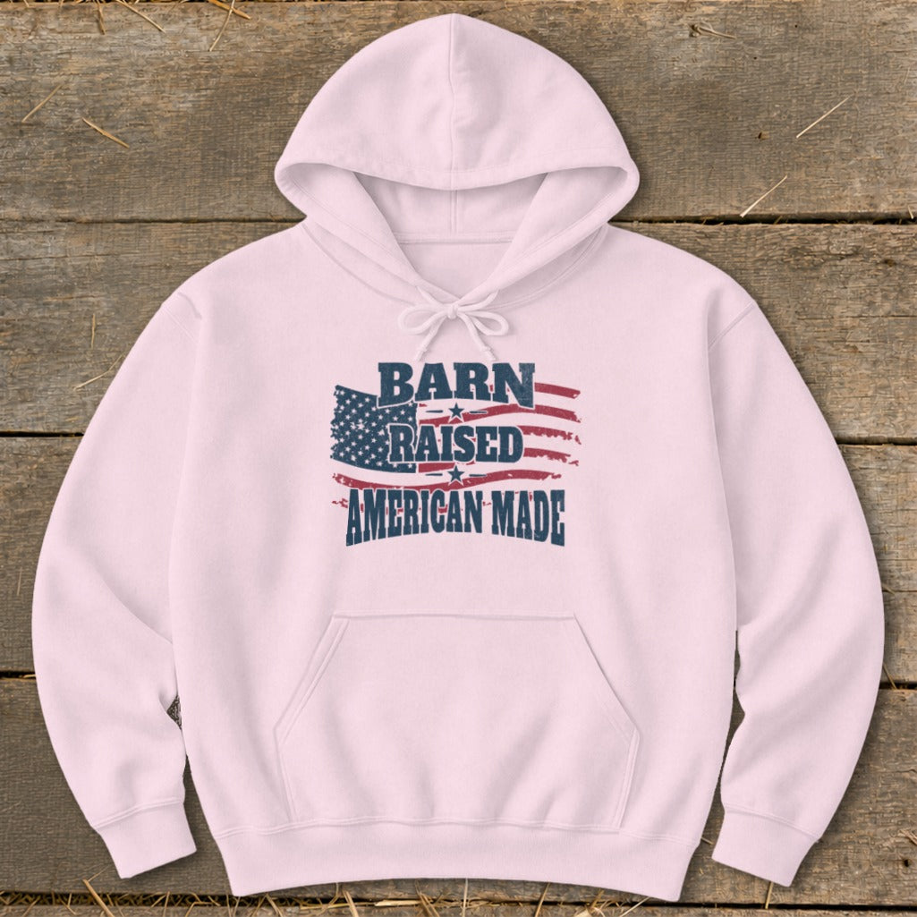 Pink hoodie with "Barn Raised American Made" text and American flag graphic.