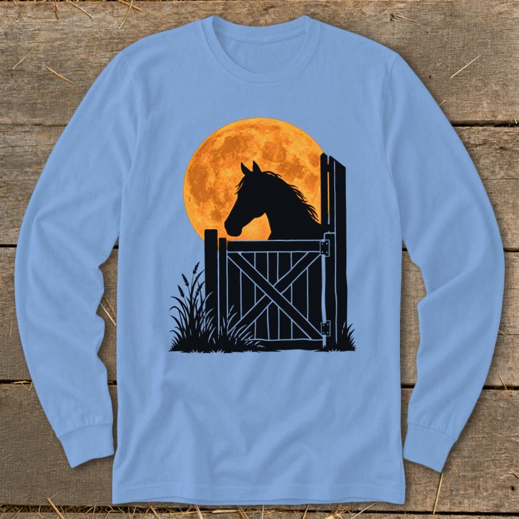 Light blue long-sleeve t-shirt featuring a black silhouette graphic of a horse looking over a stable door against a large orange full moon.