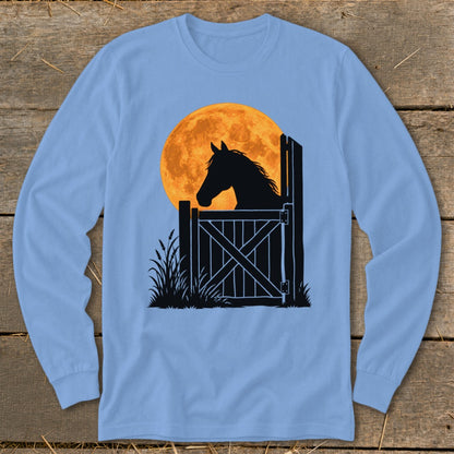 Light blue long-sleeve t-shirt featuring a black silhouette graphic of a horse looking over a stable door against a large orange full moon.