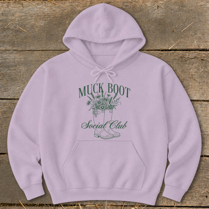 Purple hoodie with "Muck Boot Social Club" text and floral boot graphic.