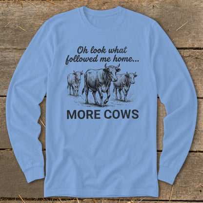 Light blue long sleeve shirt with cows and text: "Oh look what followed me home... MORE COWS"