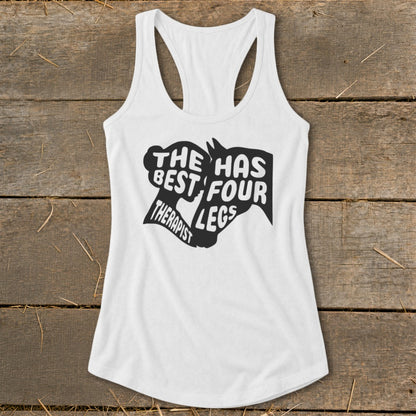 White tank top with "The Best Therapist Has Four Legs" text and horse graphic.