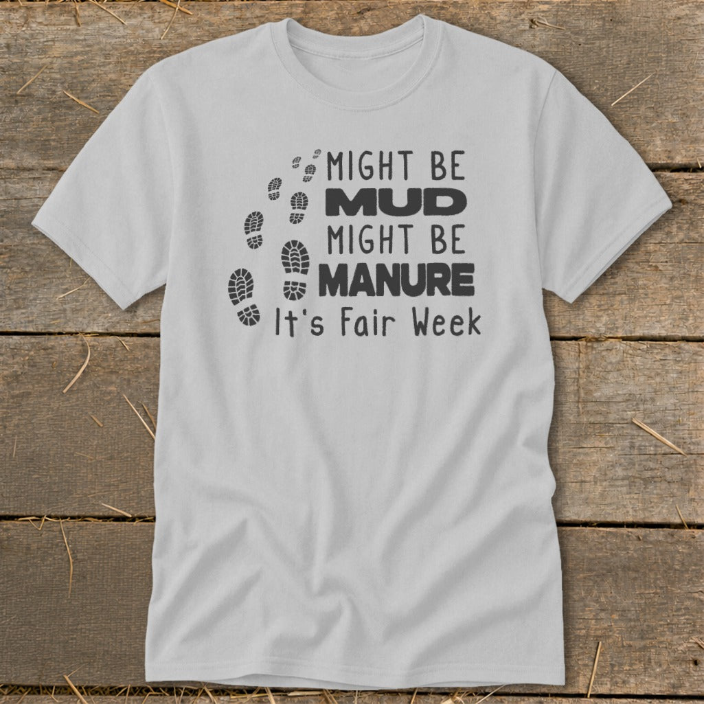 Light gray t-shirt with black text and footprint graphics that reads "MIGHT BE MUD MIGHT BE MANURE It's Fair Week".