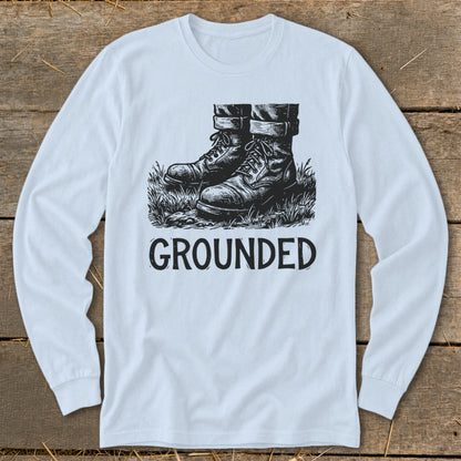 Long sleeve shirt with a graphic of boots in grass and the word "GROUNDED".