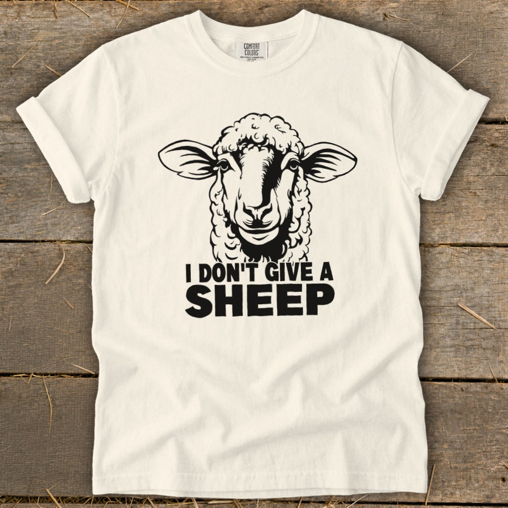 White t-shirt with black graphic of a sheep and text "I DON'T GIVE A SHEEP".