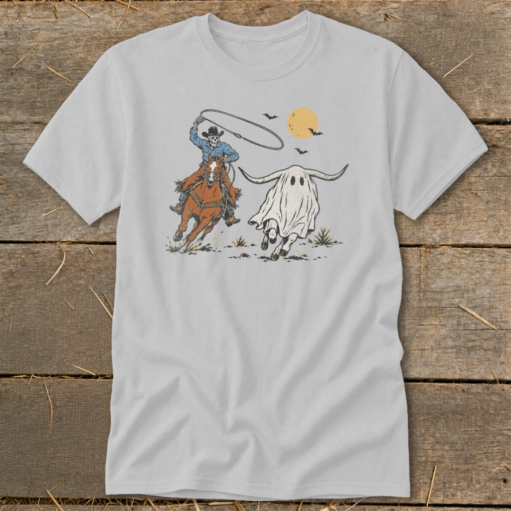 Skeleton cowboy on horseback chases a ghost longhorn under a full moon.