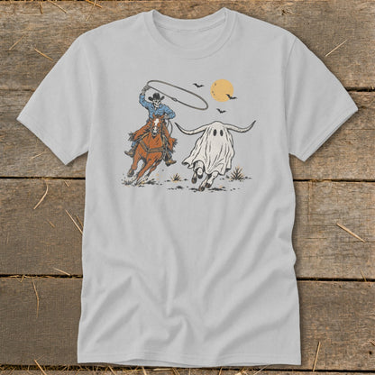 Skeleton cowboy on horseback chases a ghost longhorn under a full moon.