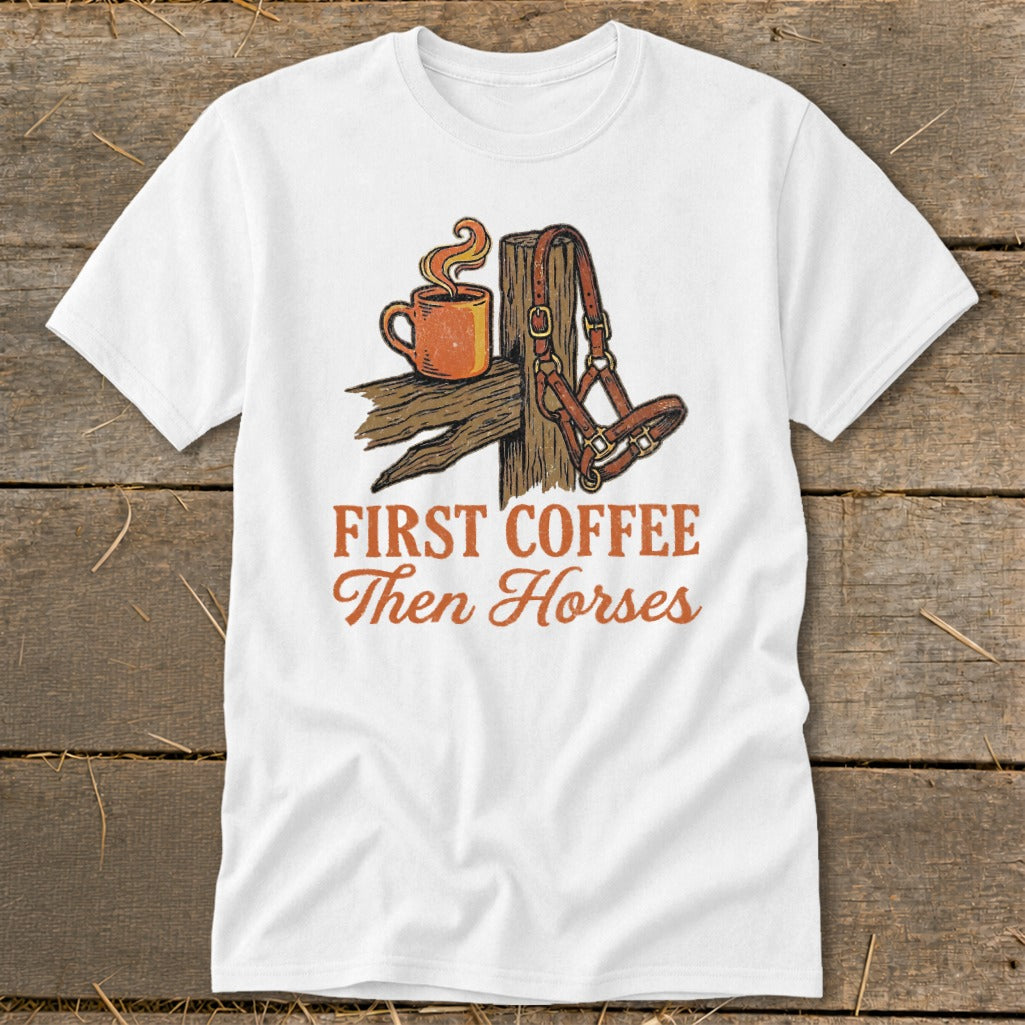 White t-shirt graphic with coffee cup, horse halter, and text "First Coffee Then Horses".