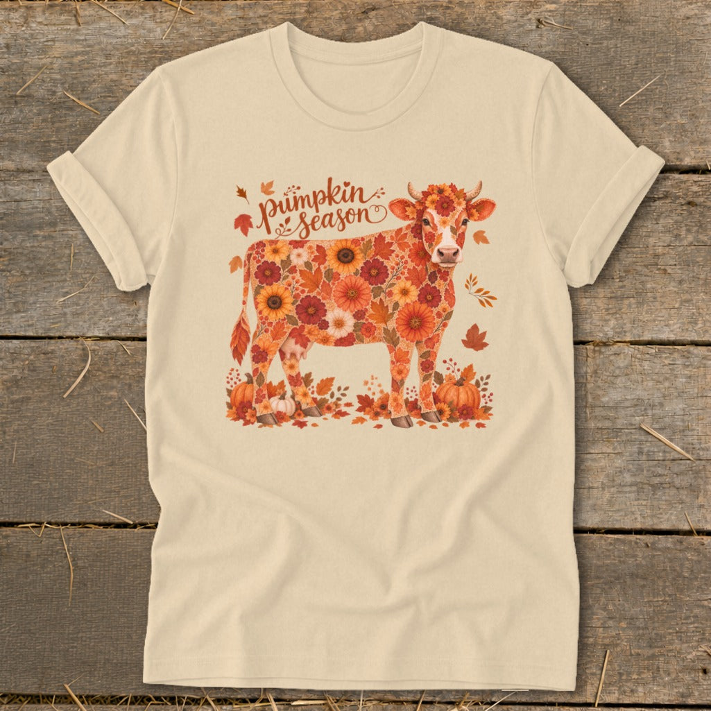Cream t-shirt with a cow made of autumn flowers and leaves, and "Pumpkin season" text.