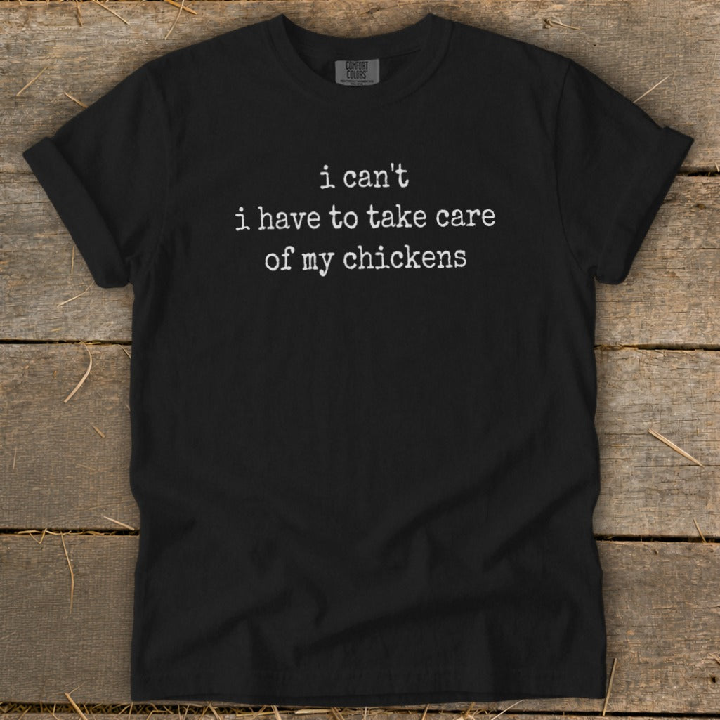 Black t-shirt with white text "i can't i have to take care of my chickens".