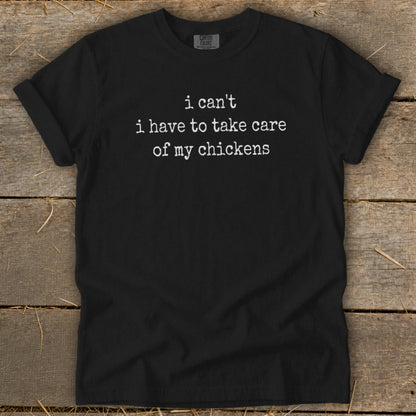 Black t-shirt with white text "i can't i have to take care of my chickens".