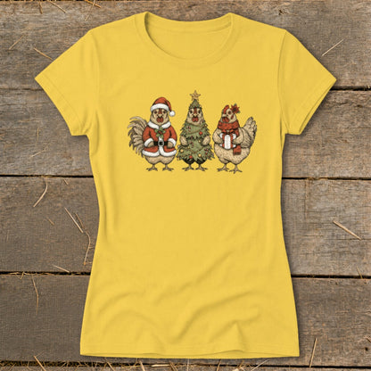 Yellow t-shirt with three cartoon chickens in holiday attire: Santa, tree, and gift holder.