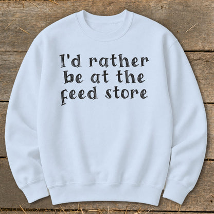 Light blue crewneck sweatshirt with "I'd rather be at the feed store" text.
