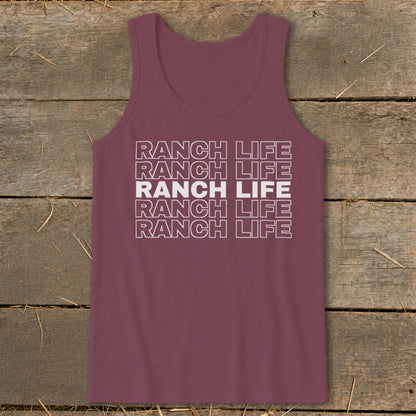 A maroon tank top with white block text reading Ranch Life stacked five times, displayed on a wooden surface.