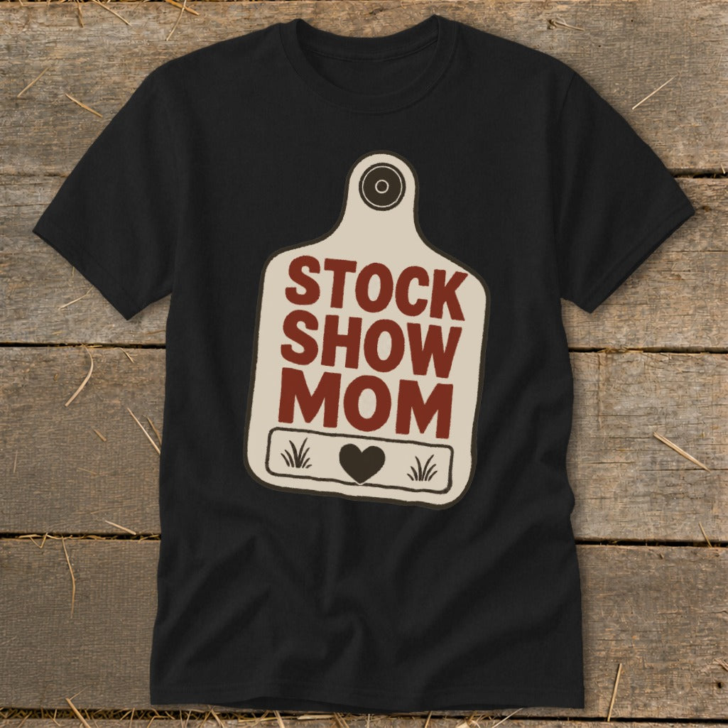 Black t-shirt with a cream-colored tag graphic that reads "STOCK SHOW MOM".