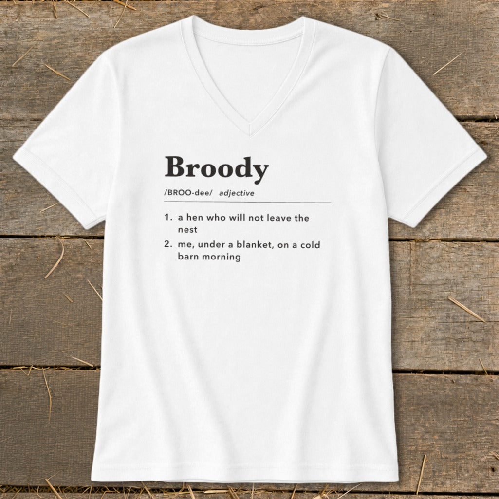 White v-neck t-shirt with "Broody" definition: "a hen who will not leave the nest" or "me, under a blanket, on a cold barn morning".