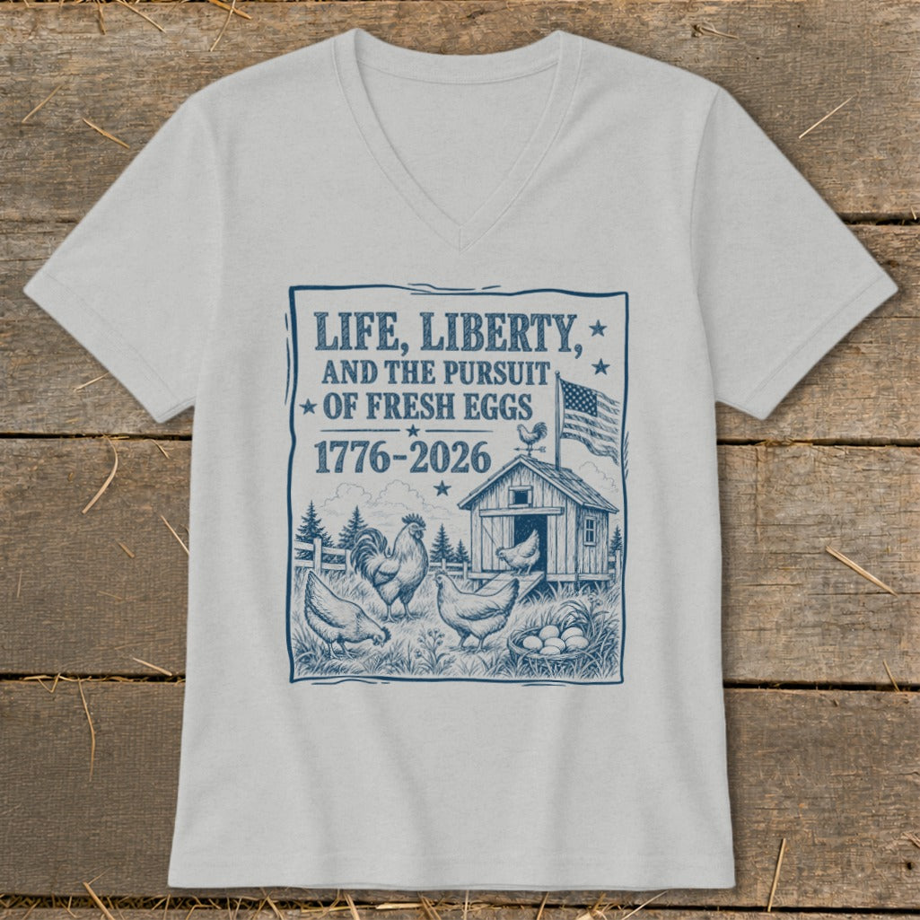 T-shirt graphic with chickens, coop, and text "Life, Liberty, and the Pursuit of Fresh Eggs 1776-2026".