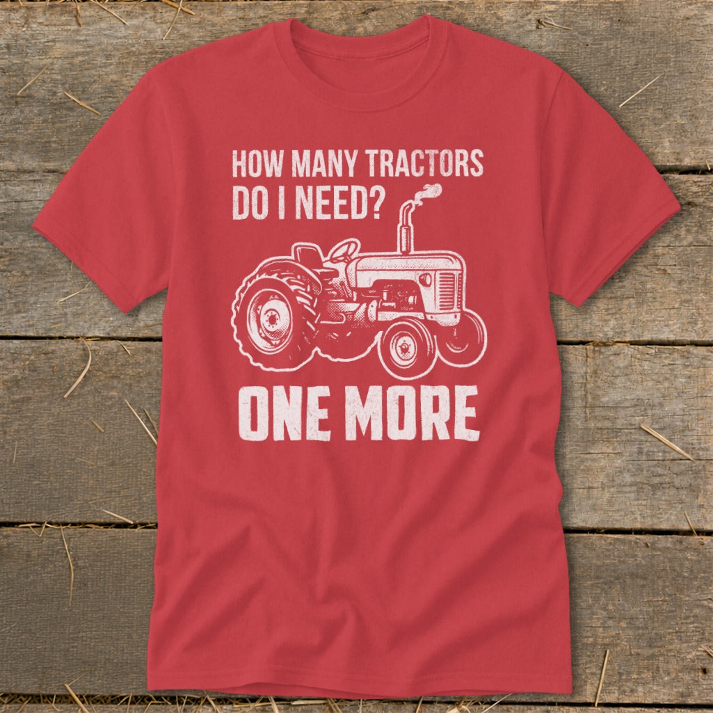 Red t-shirt with white tractor graphic and text "HOW MANY TRACTORS DO I NEED? ONE MORE".