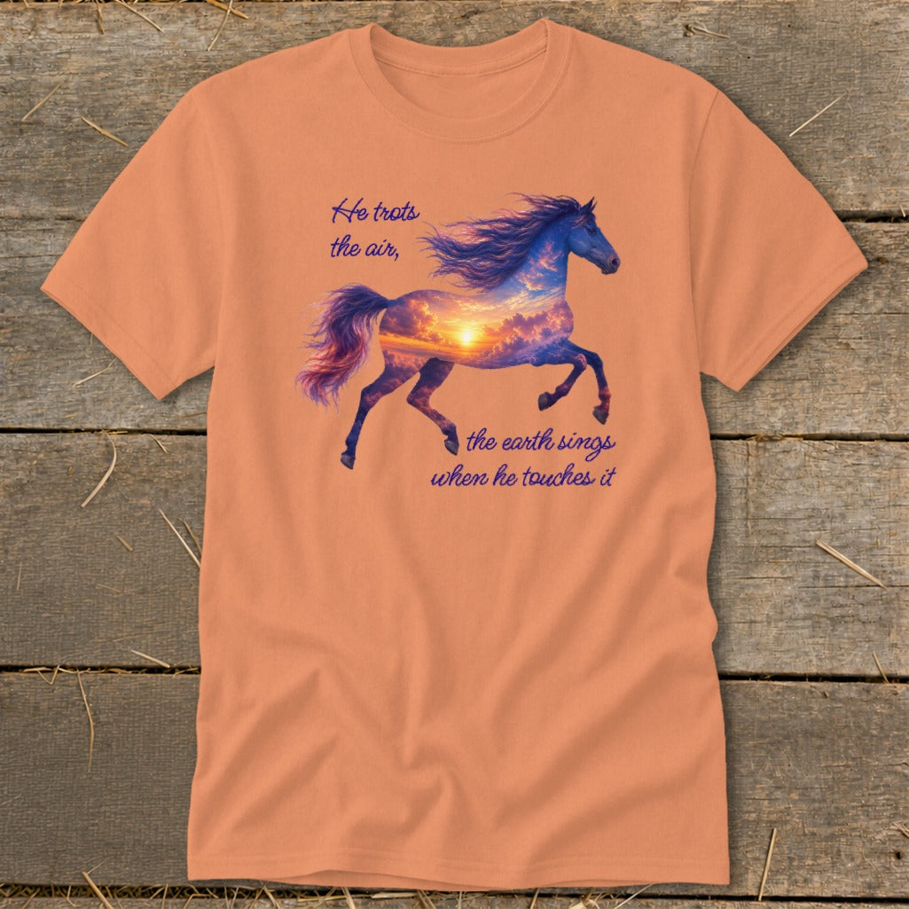 Peach-colored t-shirt featuring a galloping horse graphic with a sunset cloud body and text reading He trots the air.