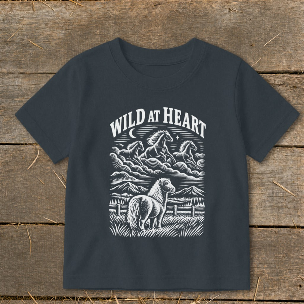 Dark t-shirt with "WILD AT HEART" text and a graphic of horses in a landscape.