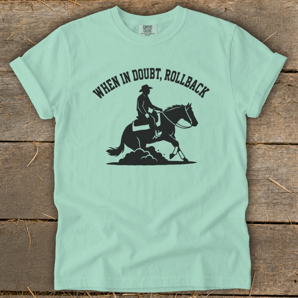 Pale green t-shirt with black graphic of a cowboy on a horse and text "WHEN IN DOUBT, ROLLBACK".