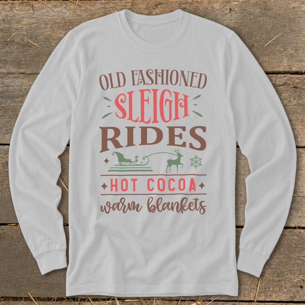 White long-sleeve shirt with "Old Fashioned Sleigh Rides Hot Cocoa Warm Blankets" text.