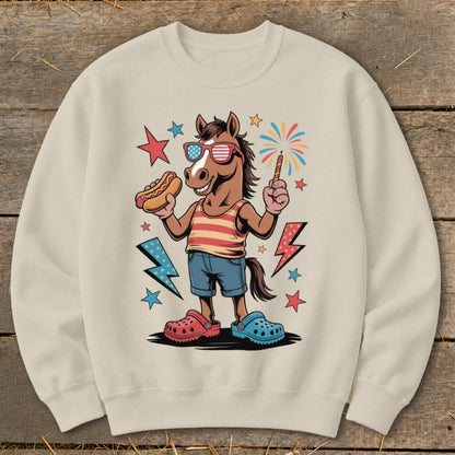 Cartoon horse wearing sunglasses holding a hot dog and sparkler with fireworks.