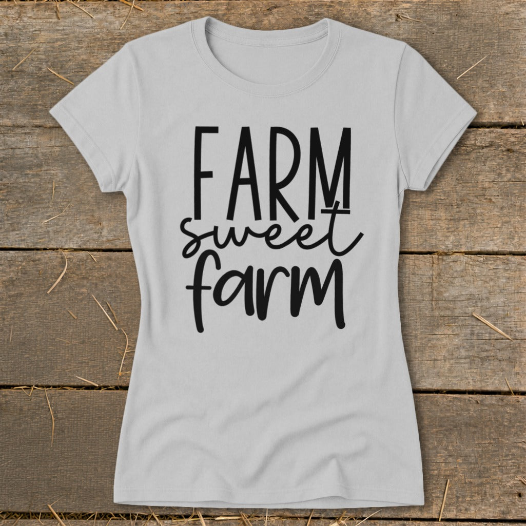 Light grey t-shirt with "FARM sweet farm" text in black, rustic background.