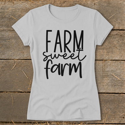 Light grey t-shirt with "FARM sweet farm" text in black, rustic background.